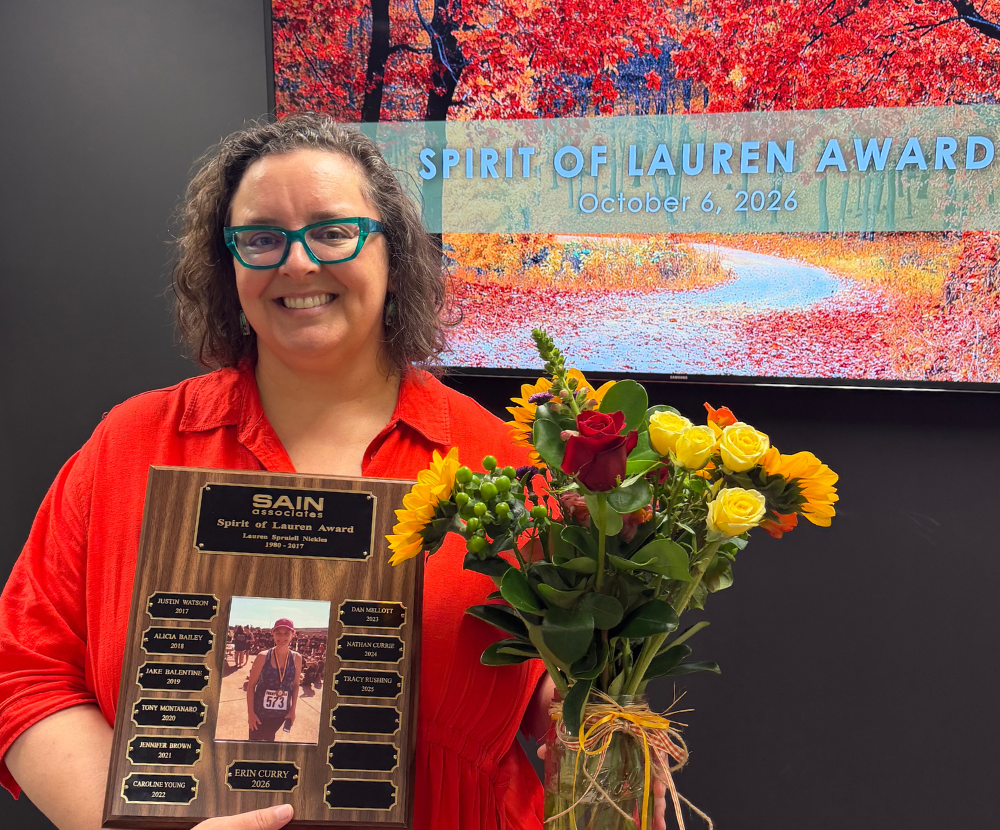 Erin Curry holds the Spirit of Lauren Award plaque.